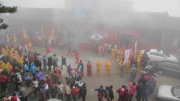 During the temple fair, performers honor the goddess, Our Lady of the Azure Clouds. Here, women flick wooden tridents into the air.